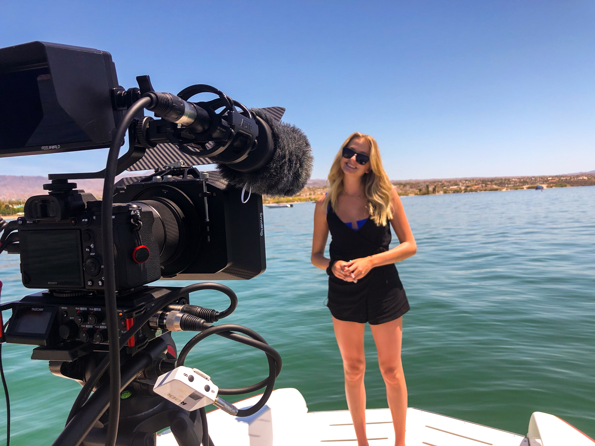 lifestyle model video shoot on lake havasu boat with camera filming subject
