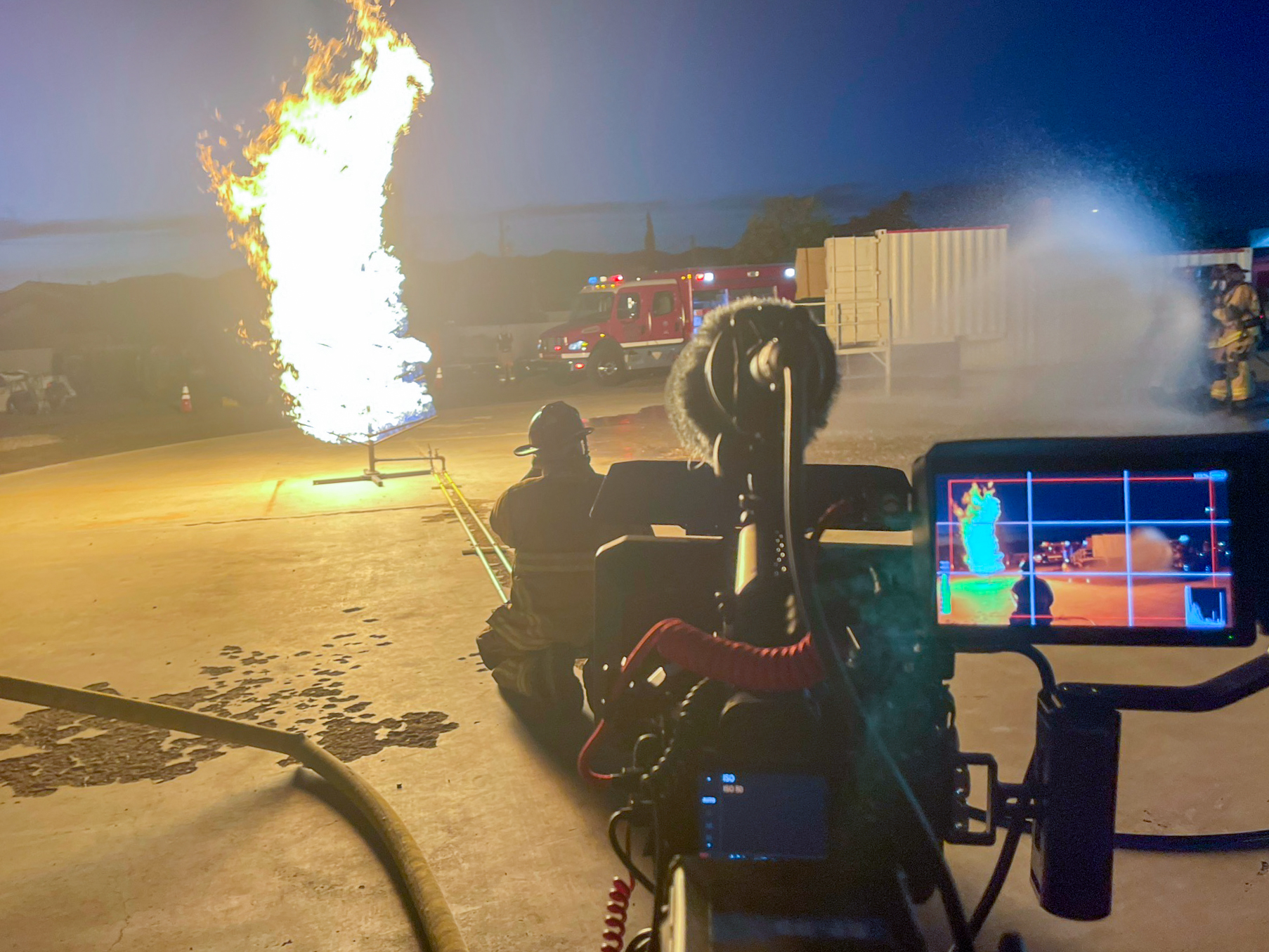 behind the scenes video production filming fire department training burn exercise with camera operator and flames