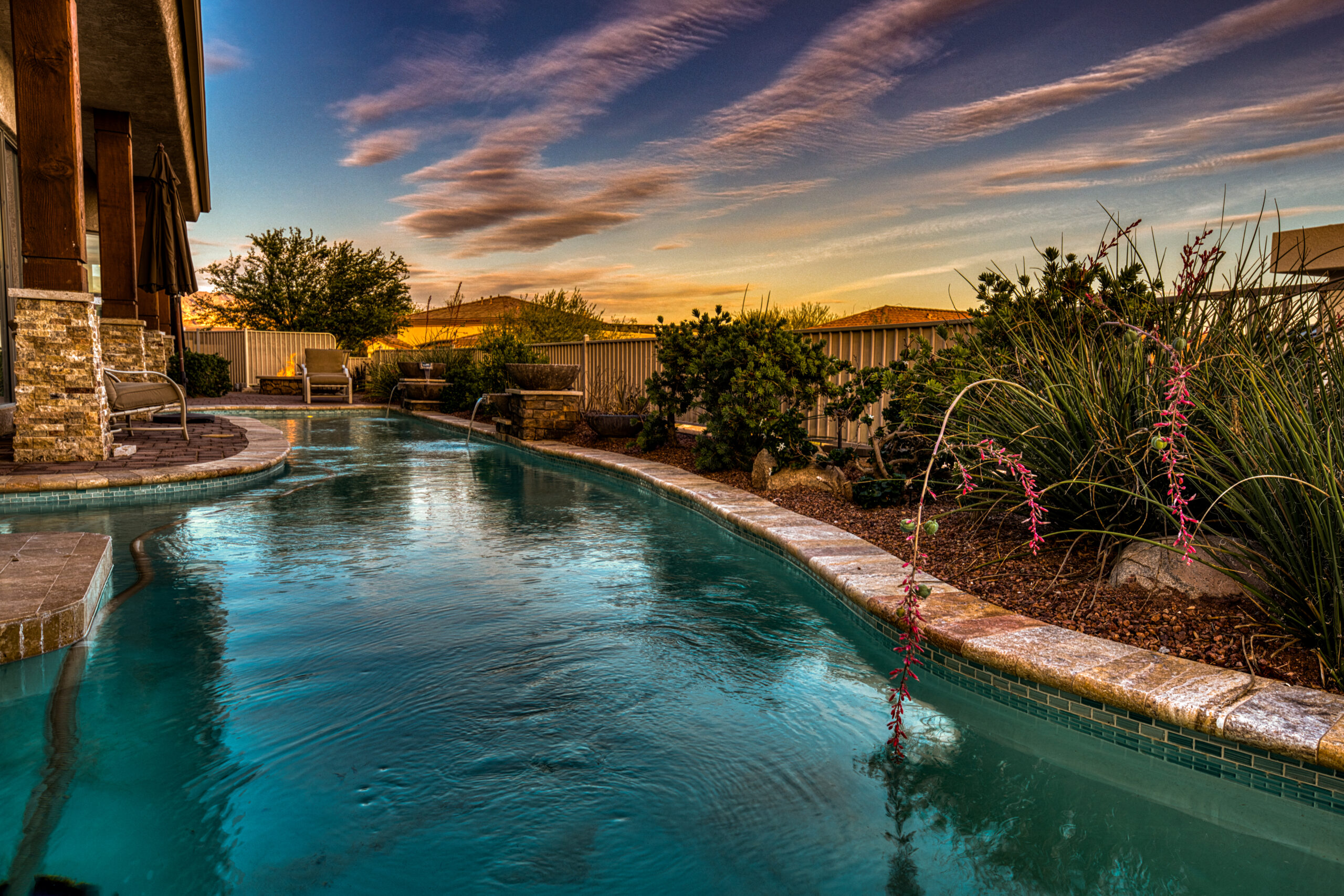 Backyard pool with desert landscaping and curved design in Lake Havasu home