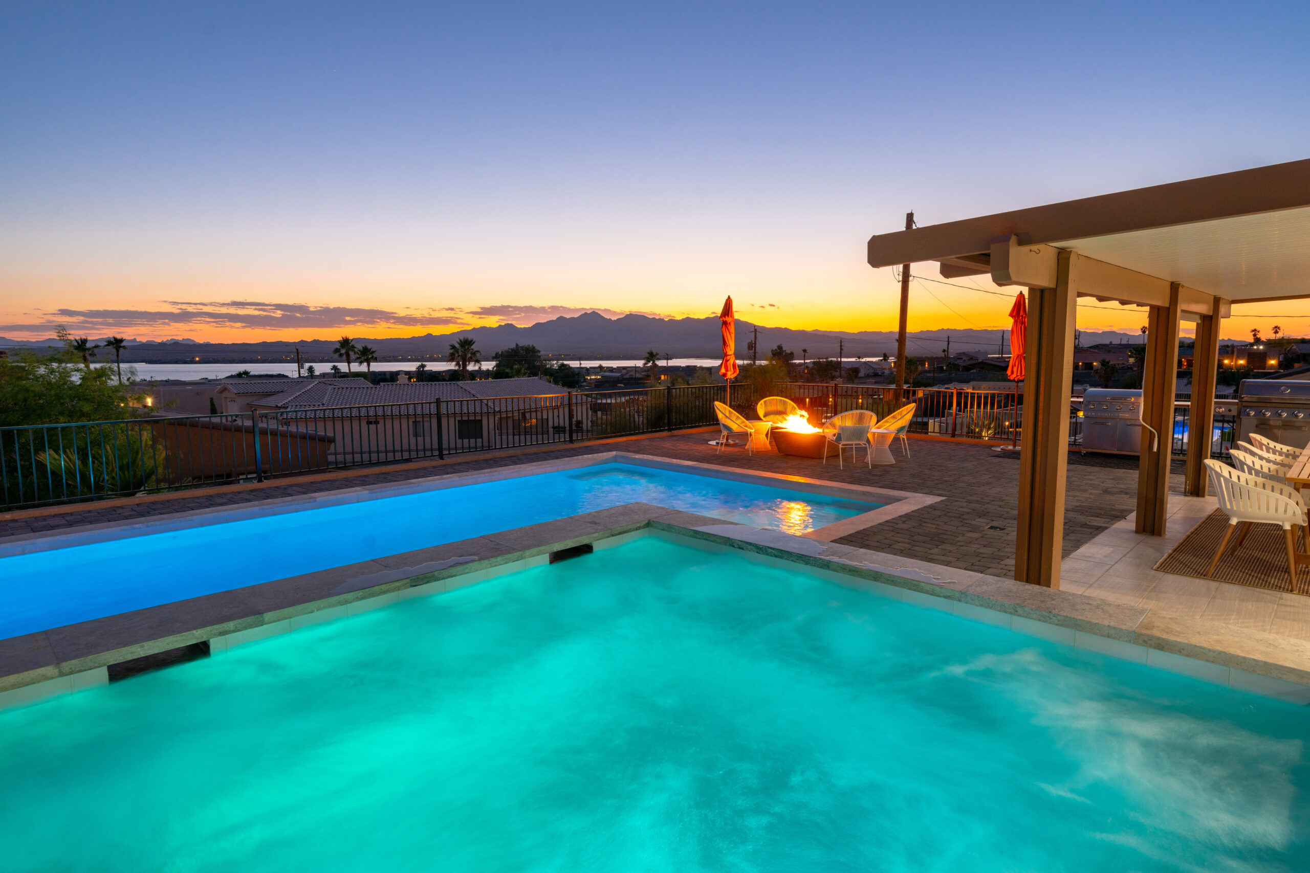 Luxury pool and spa at sunset with firepit and mountain views in Lake Havasu City