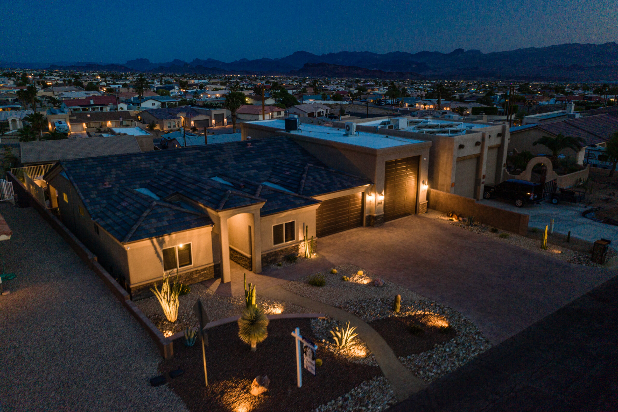 Luxury backyard with pool, patio, and firepit at night in Lake Havasu