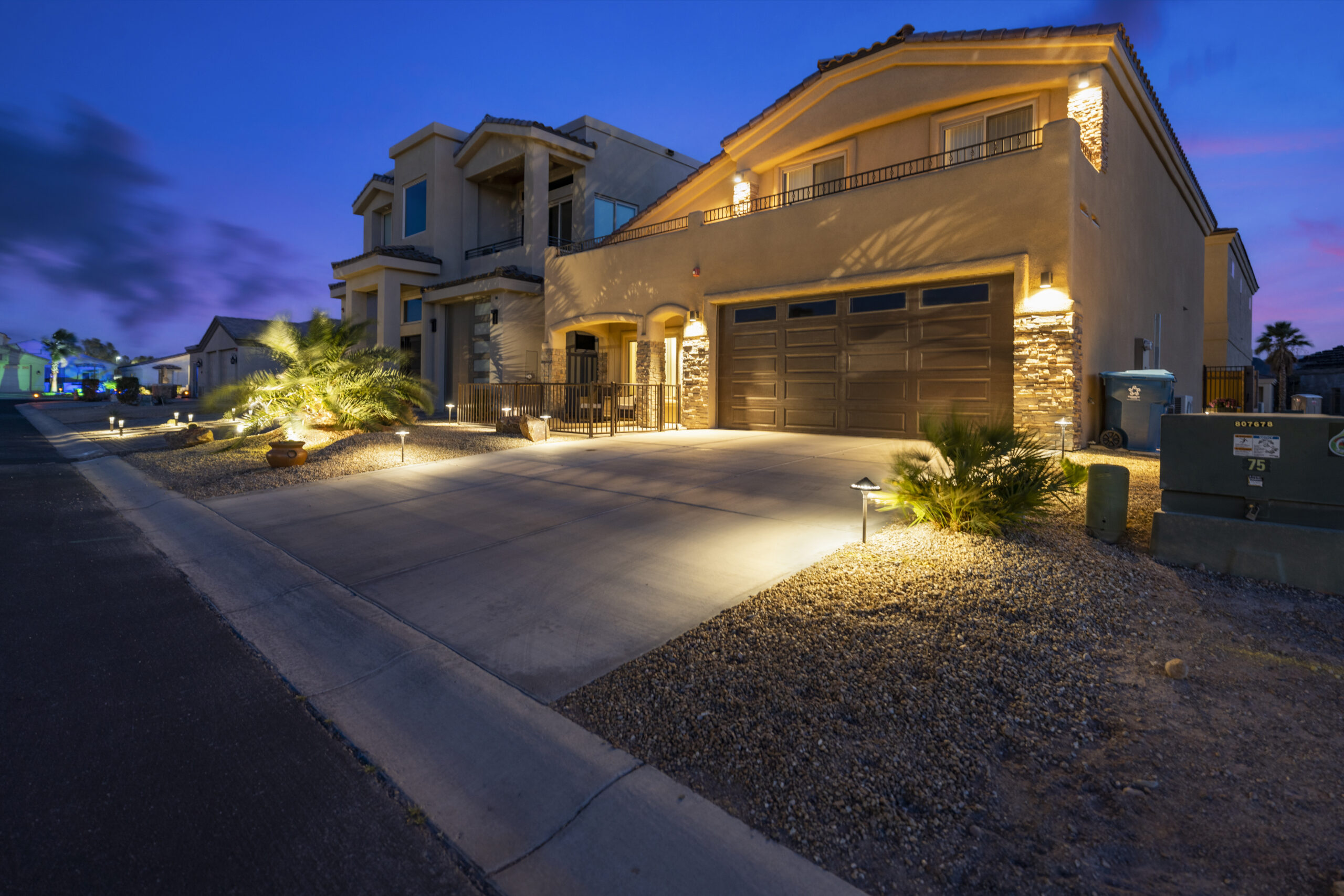 Luxury home front exterior at blue hour with landscape lighting in Lake Havasu